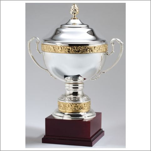 Silver Plated Italian Cup with gold edging and lid with a golden acorn top on a rosewood base.